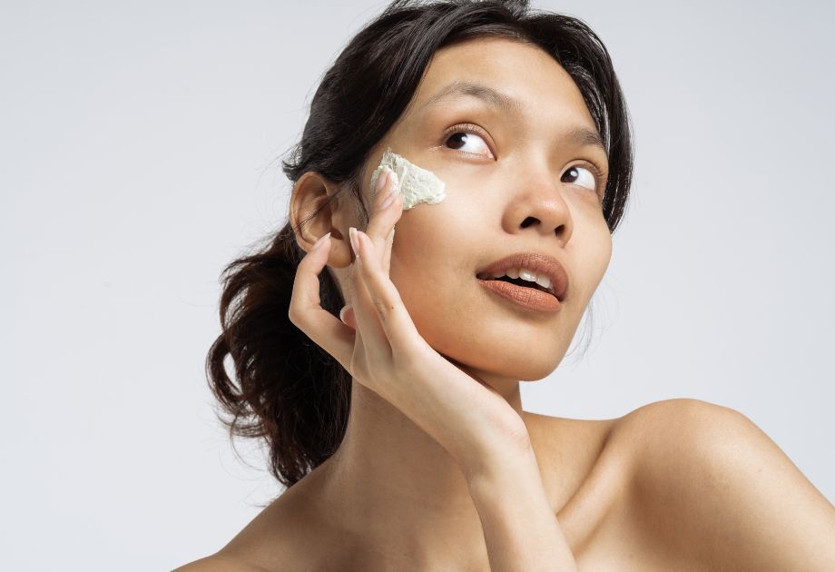 woman applying sunscreen to face